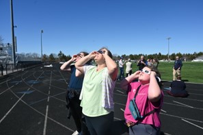 students viewing eclipse on track