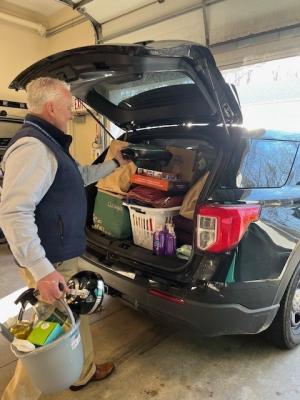 Chief Kilbride loads donated goods into trunk of vehicle