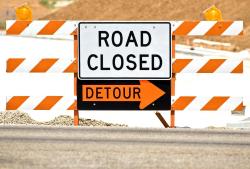 road closed barricade with detour sign