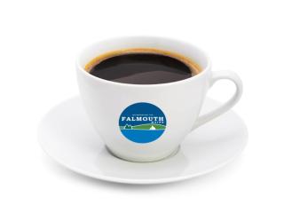 white coffee cup with Falmouth logo on it filled with coffee